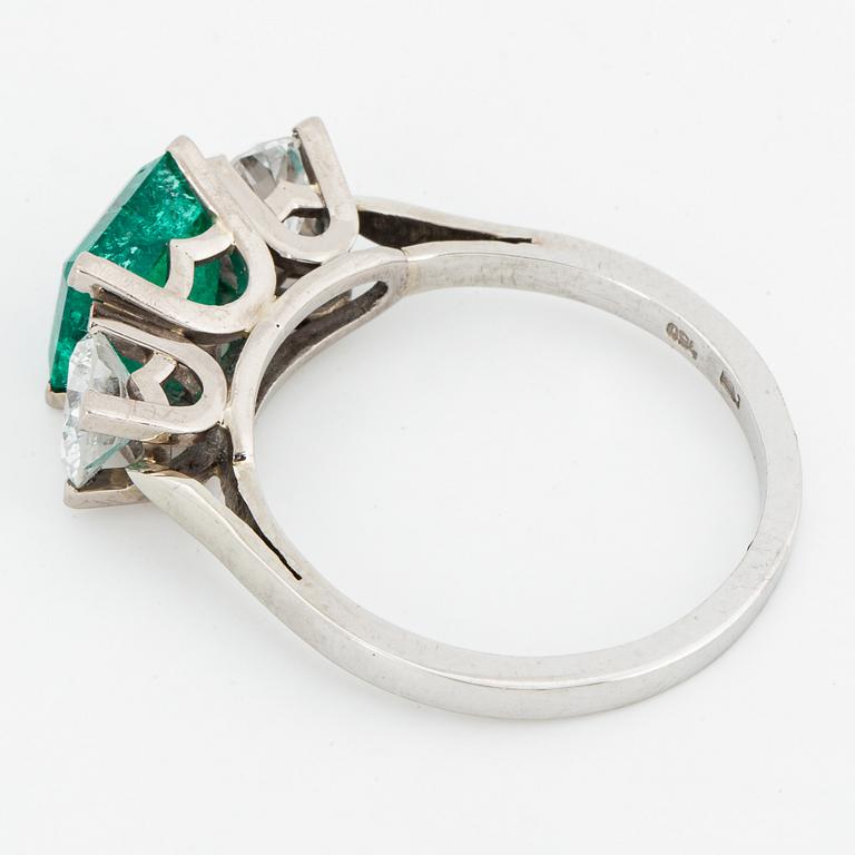 Emerald and brilliant-cut diamond three stone ring.