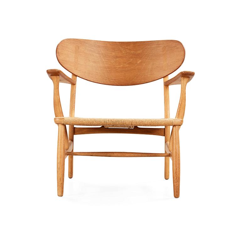 A Hans J Wegner 'CH-22' oak easy chair, Carl Hansen & Son, Odense, Denmark.