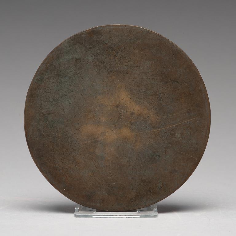 A lion and grapewine bronze mirror, Tang dynasty (618-907).