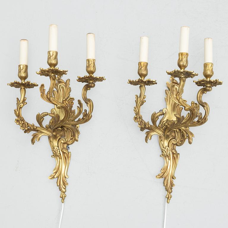 A pair of Rococo style wall lamps, early 20th Century.
