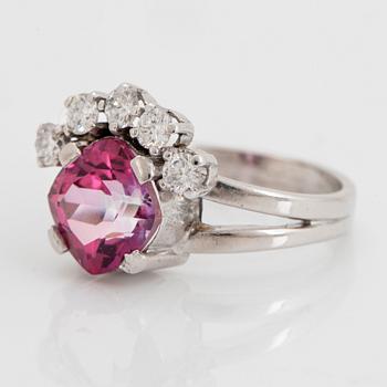 An 18K white gold ring set with a pink topaz and round brilliant-cut diamonds.