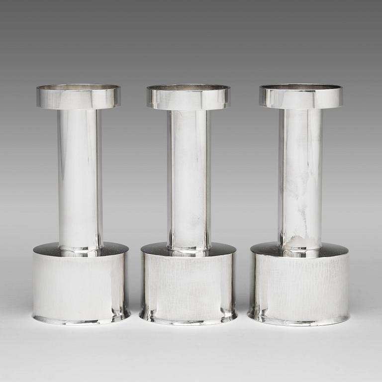 Sigurd Persson, a set of three sterling silver candlesticks, Stockholm 1965 and 1970, executed by Johann Wist.