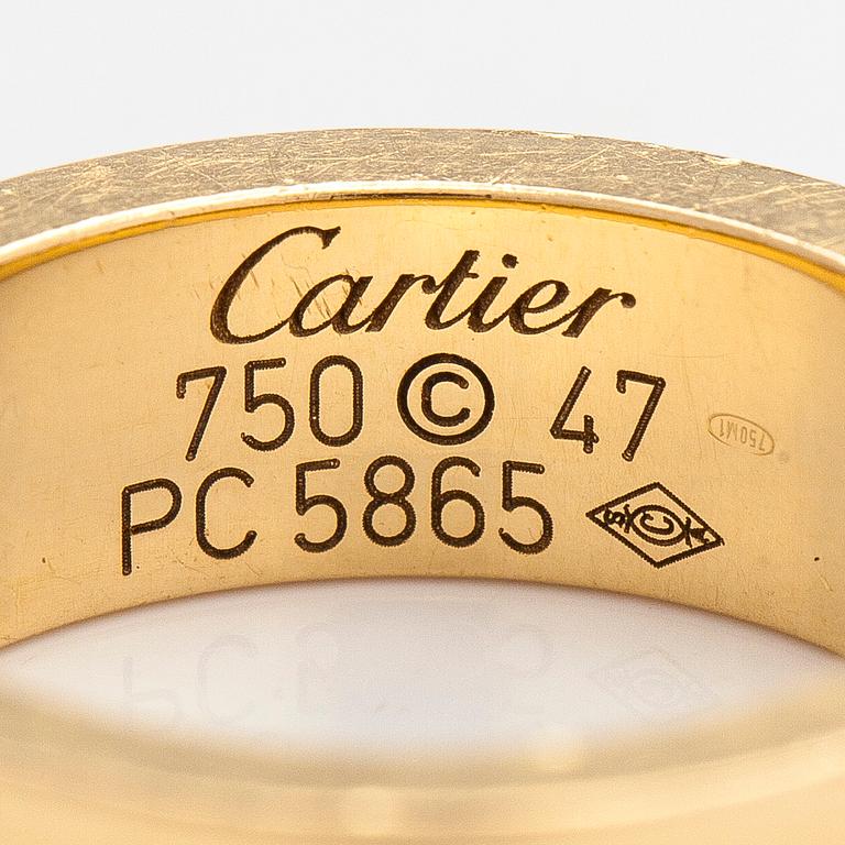 Cartier, an 18K gold 'Love' ring with three brilliant-cut diamonds.