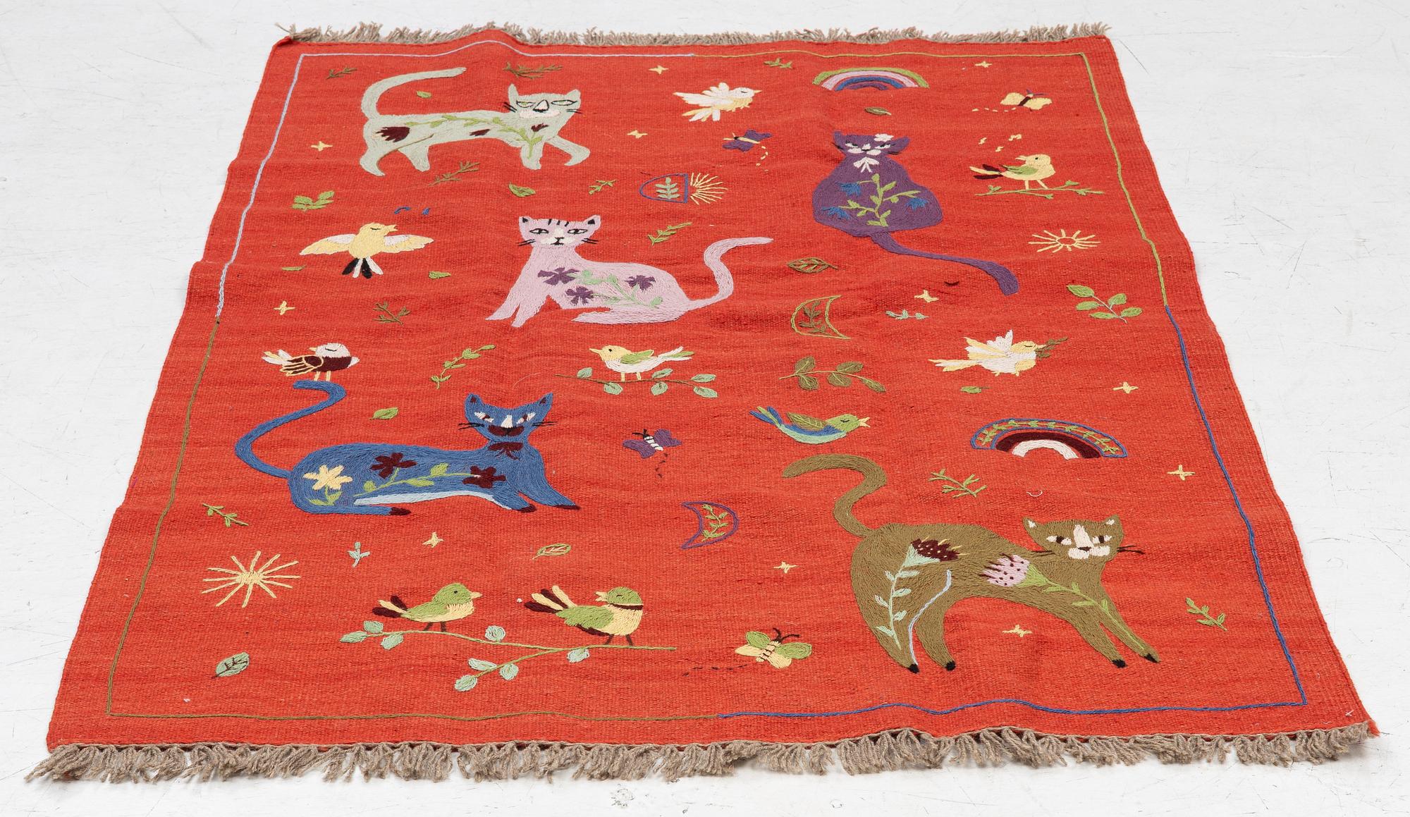 A hand-embroidered Kilim rug, c. 182 x 122 cm.