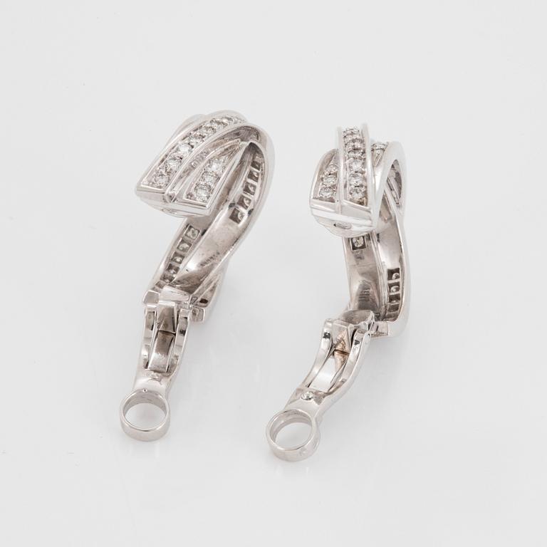 A pair of Cartier "Trinity" earrings in 18K white gold set with round brilliant-cut diamonds.