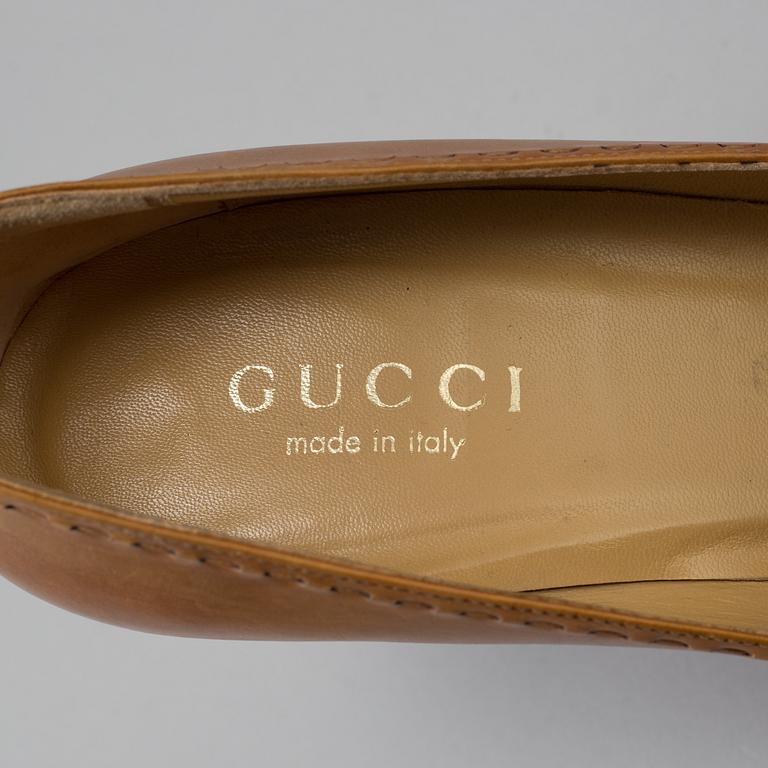 A pair of pumps by Gucci.