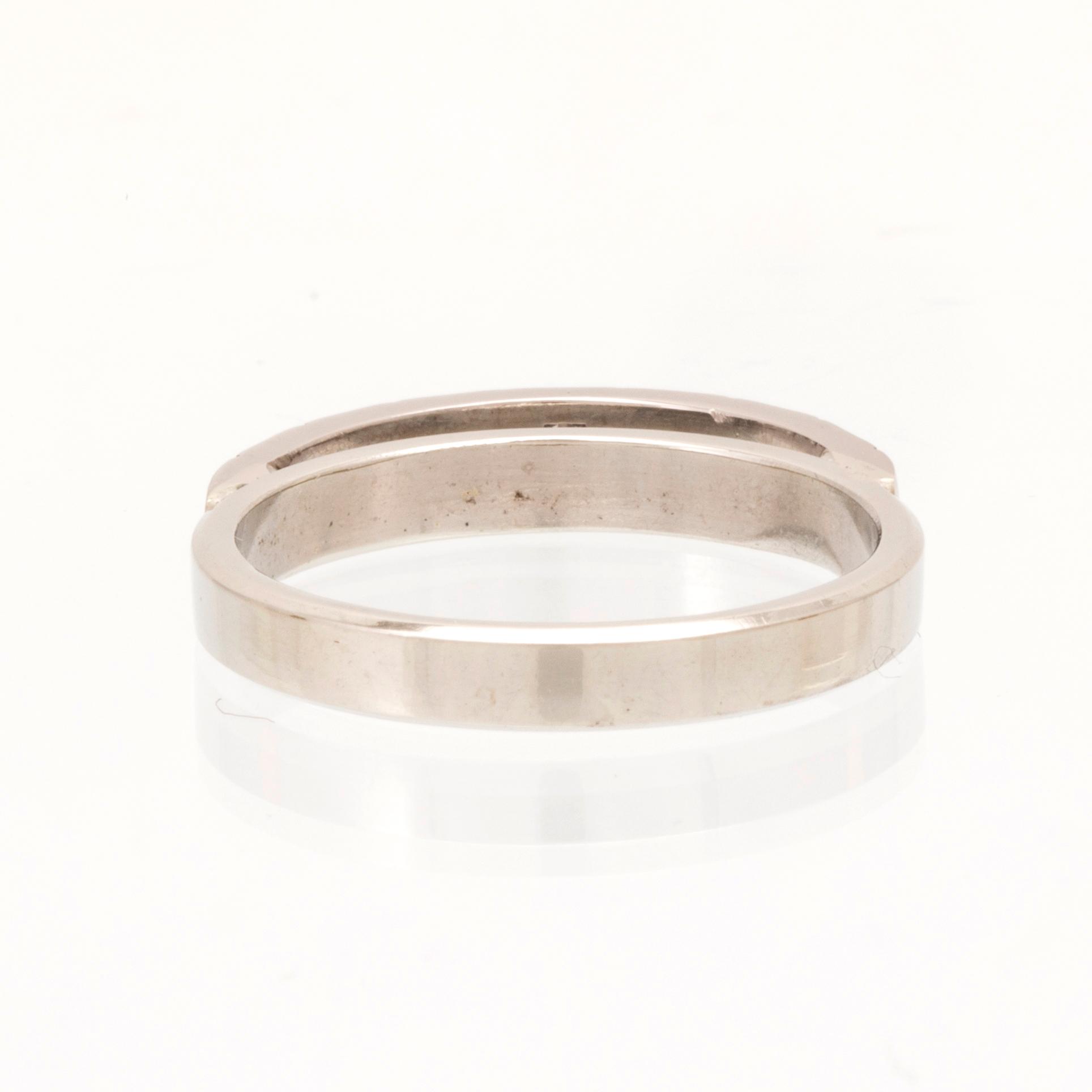 An 18K white gold ring set with round single cut dimamonds.