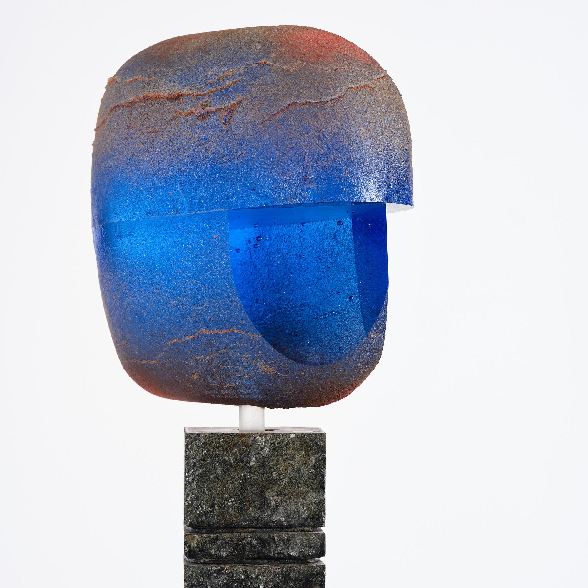 Bertil Vallien, a unique sand-cast glass sculpture of a head, on a high pedestal of polished limestone, Kosta Boda.