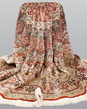 An Oriental silk rug, diameter 256 cm.