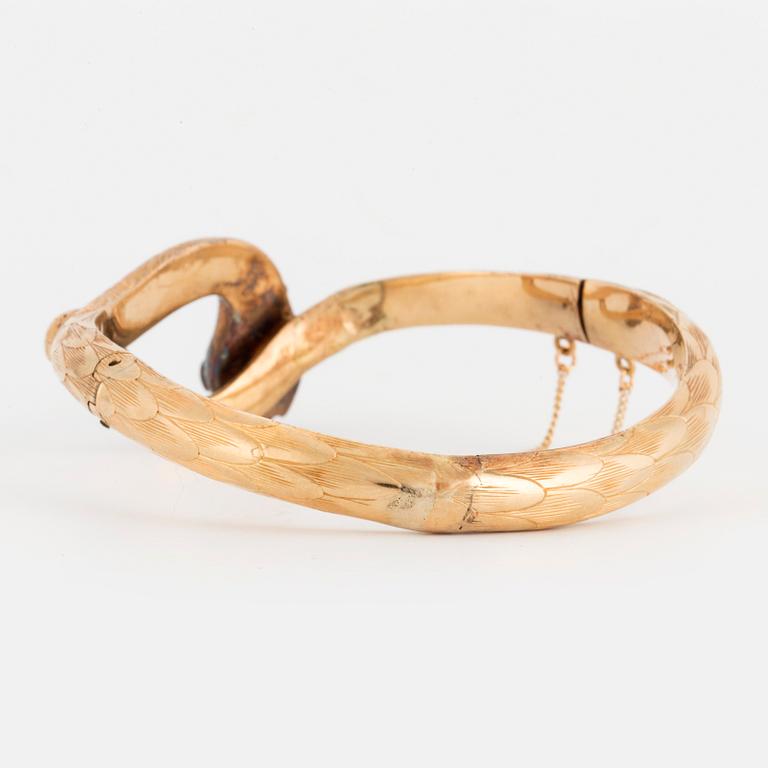 An 18K gold snake bangle with rose-cut diamonds.