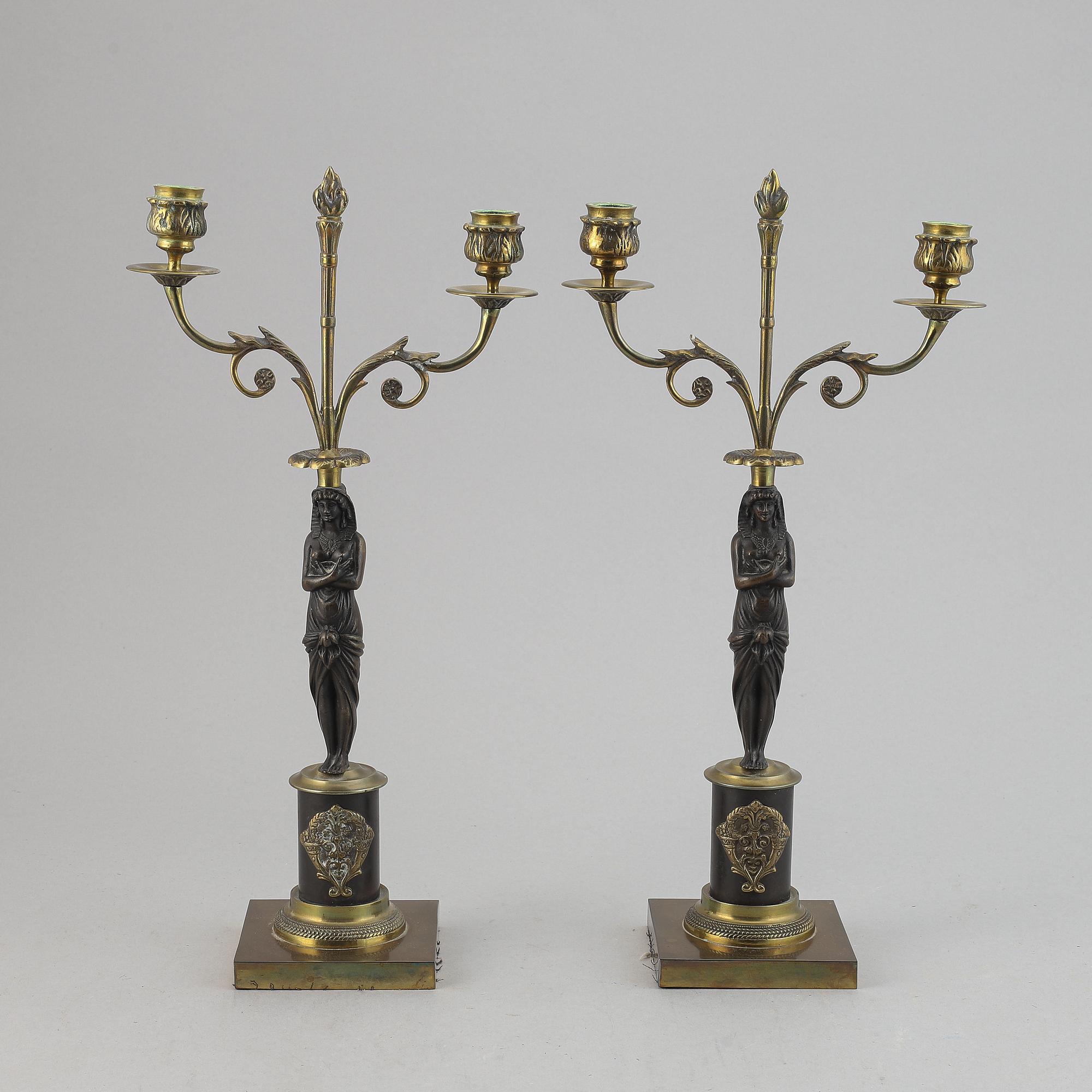 A pair of brass Empire style candle holders, 20th century.