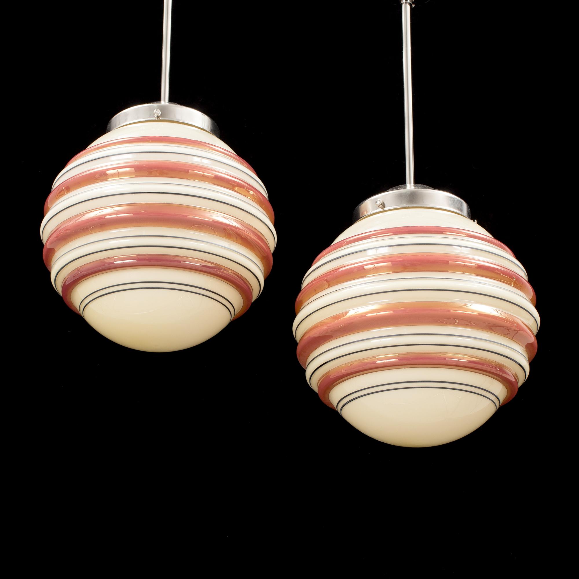 A pair och metal and and glass ceiling lights from the 1940s. Height ca 59 cm.