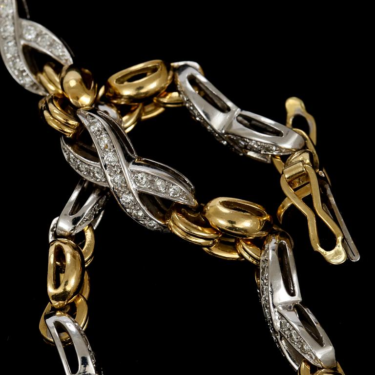 ARMLÄNK, 18 k vit- samt rödguld med små briljantslipade diamanter tot ca 1 ct. Vikt tot c:a 25,6 g.