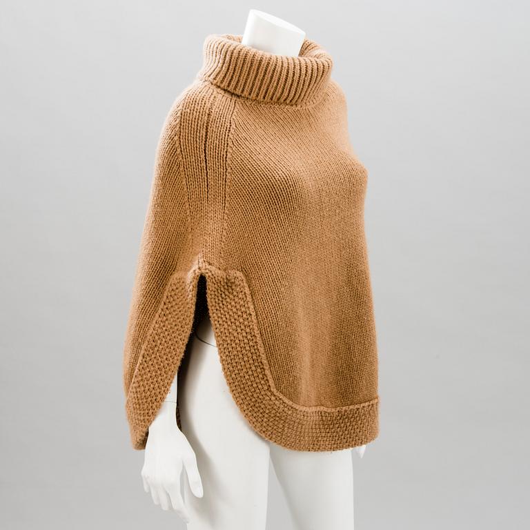 GUCCI, CAMEL HAIR PONCHO AND A HAT.