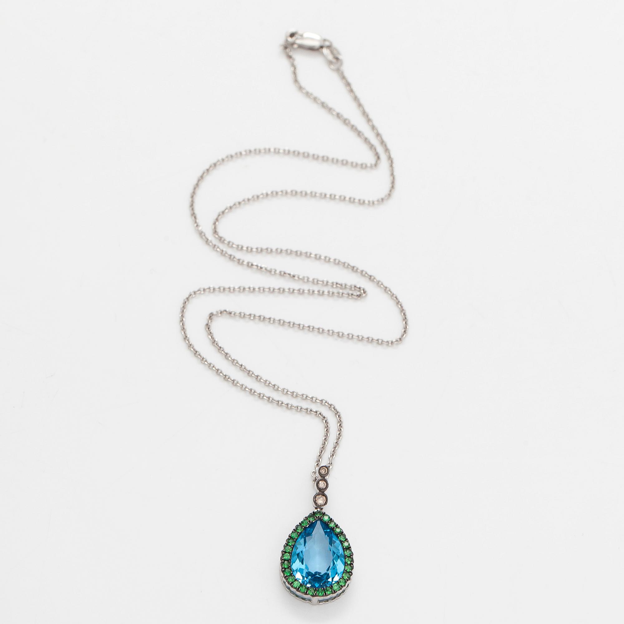 A 14K white gold necklace with pendant, topaz, brown diamonds.