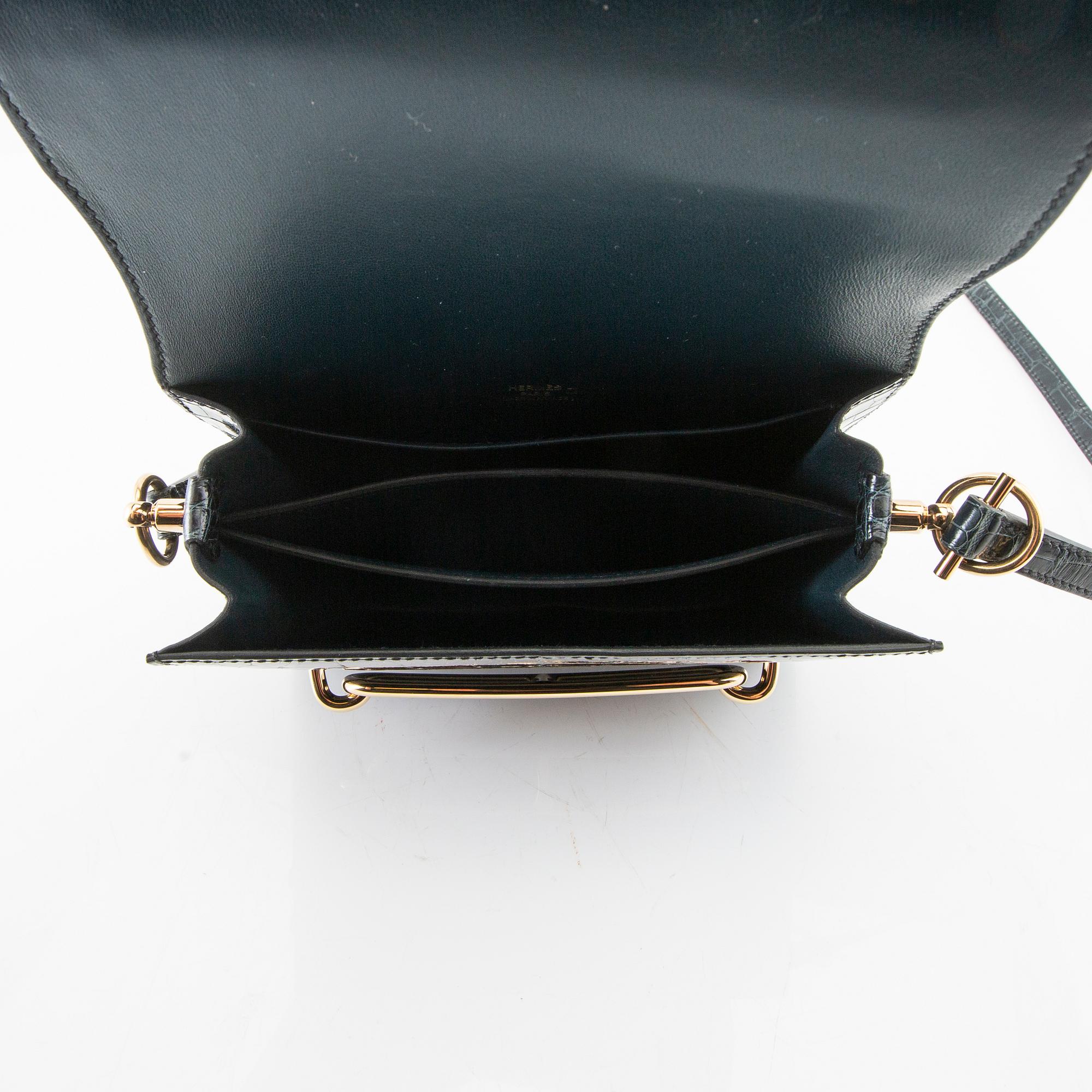 Hermès, bag "Green Shiny Alligator Mini Roulis 18 Permabrass Hardware" 2021.