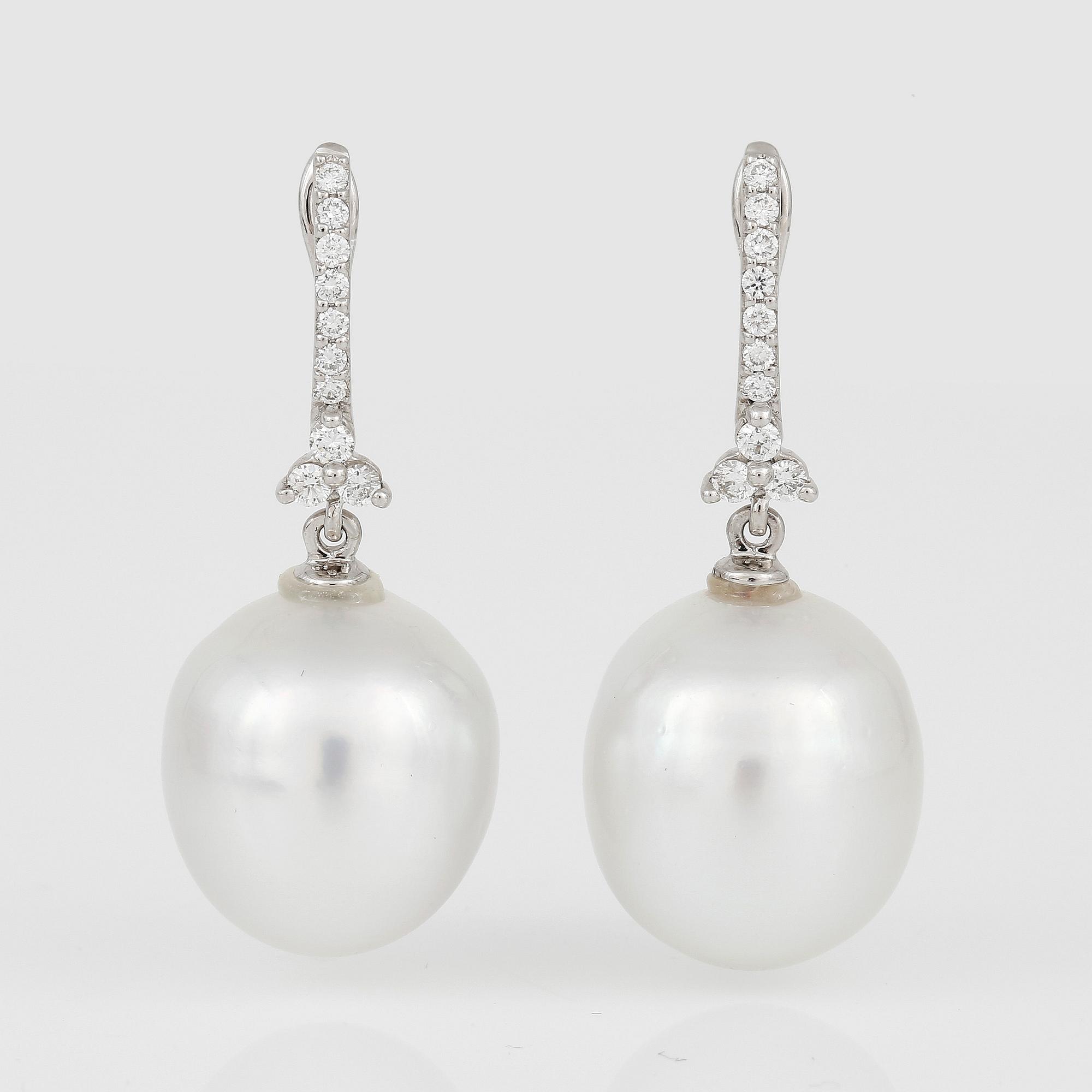 ÖRHÄNGEN, ett par, med odlade 'South Sea' pärlor och små diamanter.