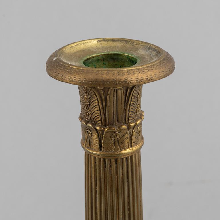 A pair of Empire gilt brass candle sticks, first half of the 20th century.