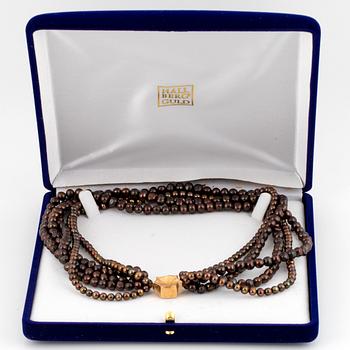 A five strand cultured pearl necklace.
