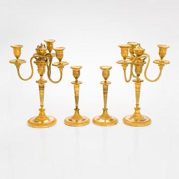 A pair of early 19th century French candelabrums and candlesticks.