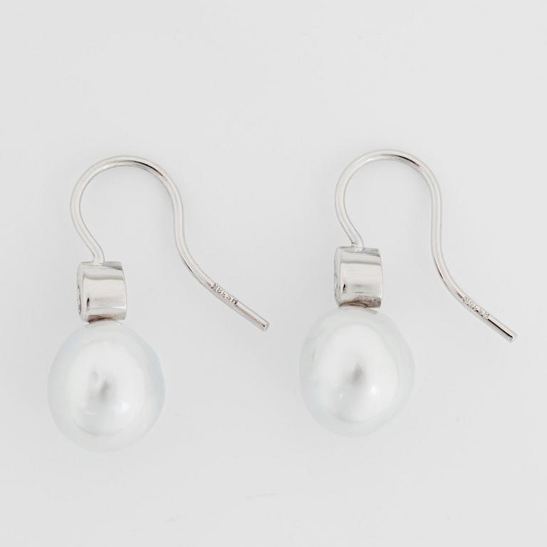 A pair of cultured South Sea pearl and diamond earrings. Total carat weight of diamonds 0.24 ct.