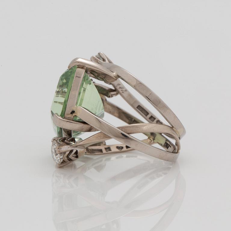 A circa 17.00 ct green beryl and brilliant cut diamond ring. Total carat weight of diamonds circa 1.29 cts.