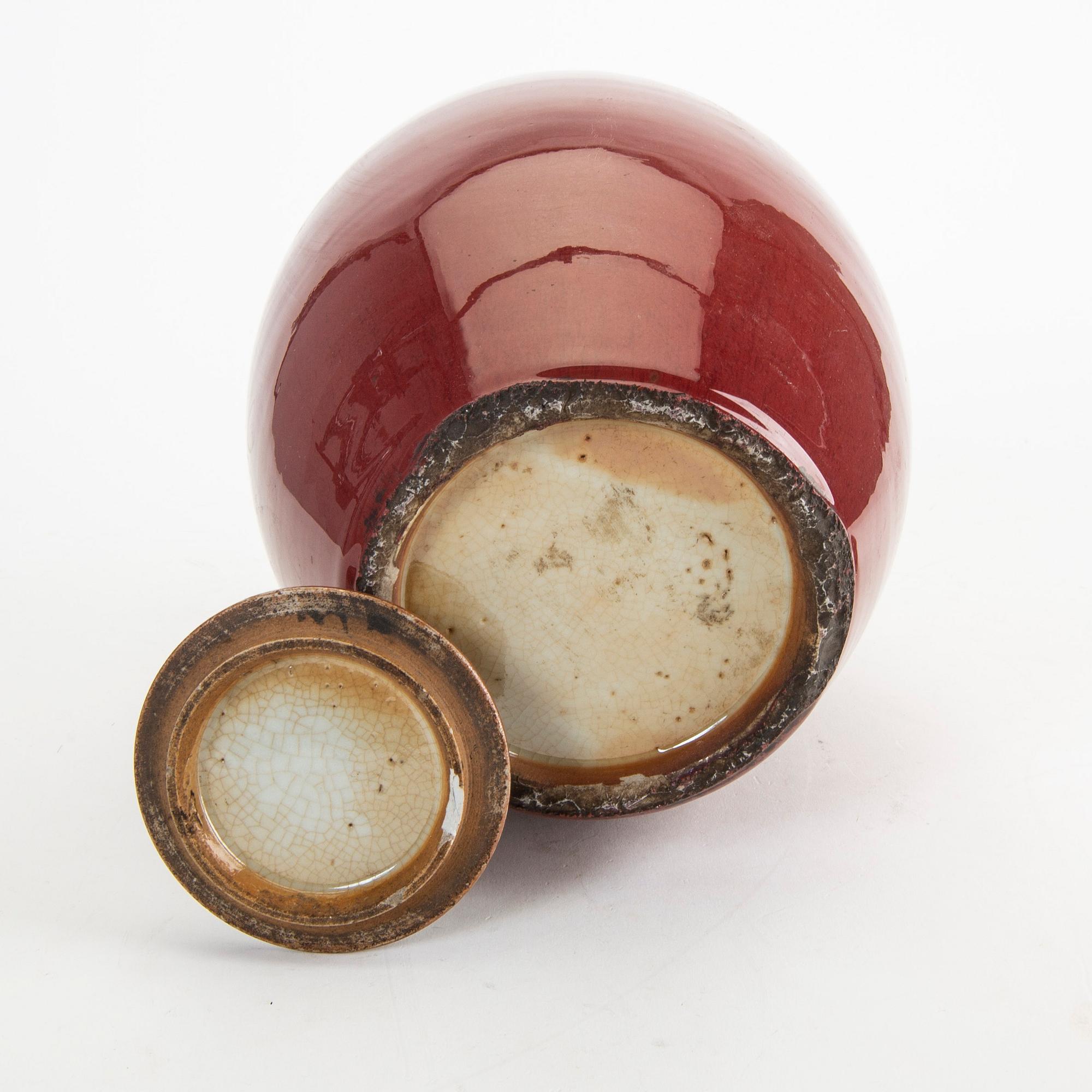 A sang de boef/flambe glazed jar with cover, Qing dynasty, circa 1900.