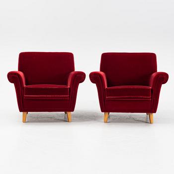 A pair of velvet upholstered easy chairs, mid 20th Century.