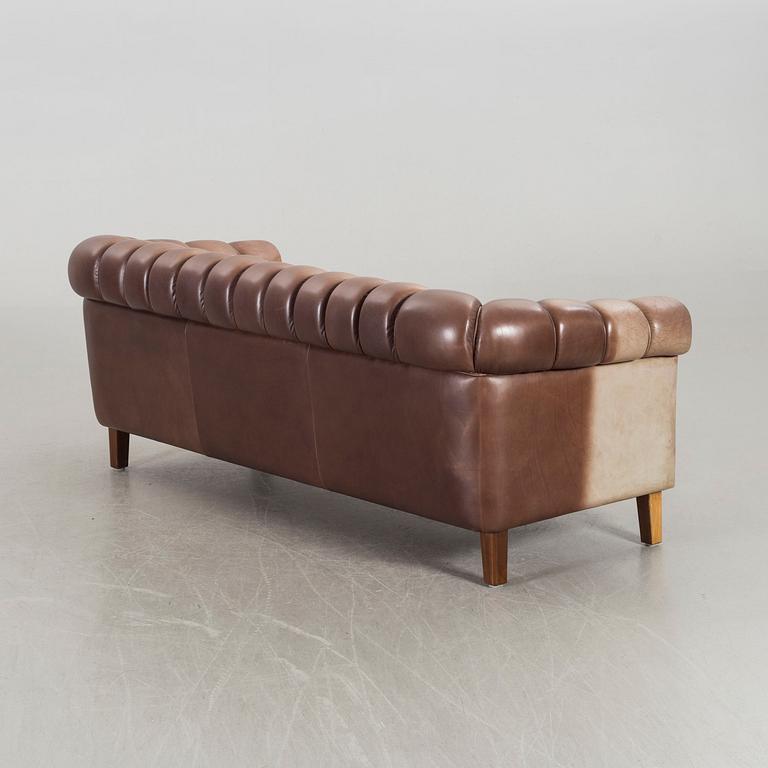 A leather sofa and armchair, 20th century latter part.