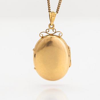 An 18K gold locket pendant, with chain in 14K gold.