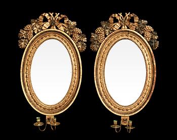 599. A pair of Swedish Empire early 19th century two-light girandole mirrors.