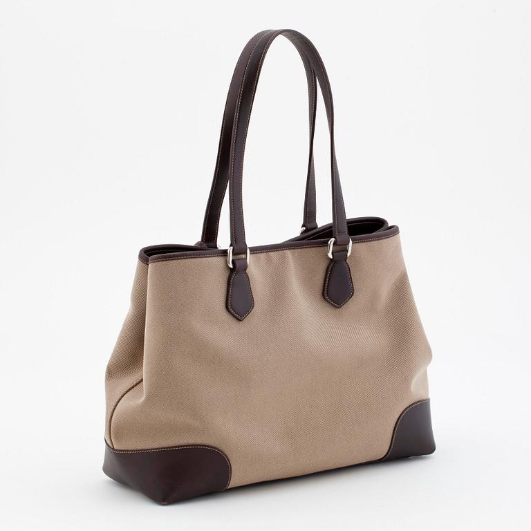 PRADA, a brown canvas and leather shoulderbag.