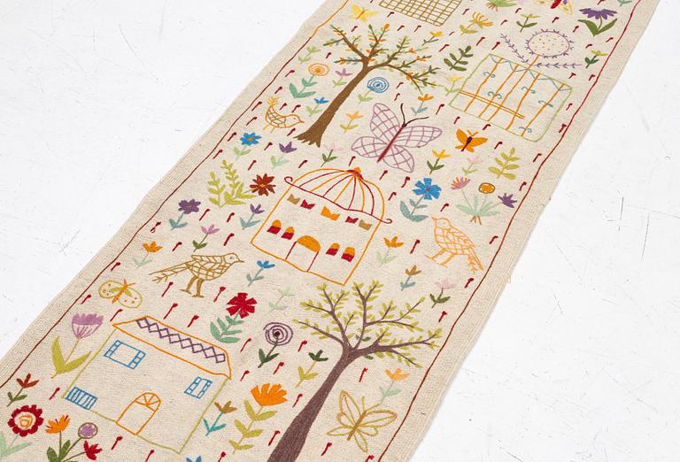 A hand-embroidered kilim runner, c. 300 x 80 cm.