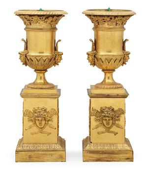 720. A pair of French Empire early 19th century gilt bronze urns.