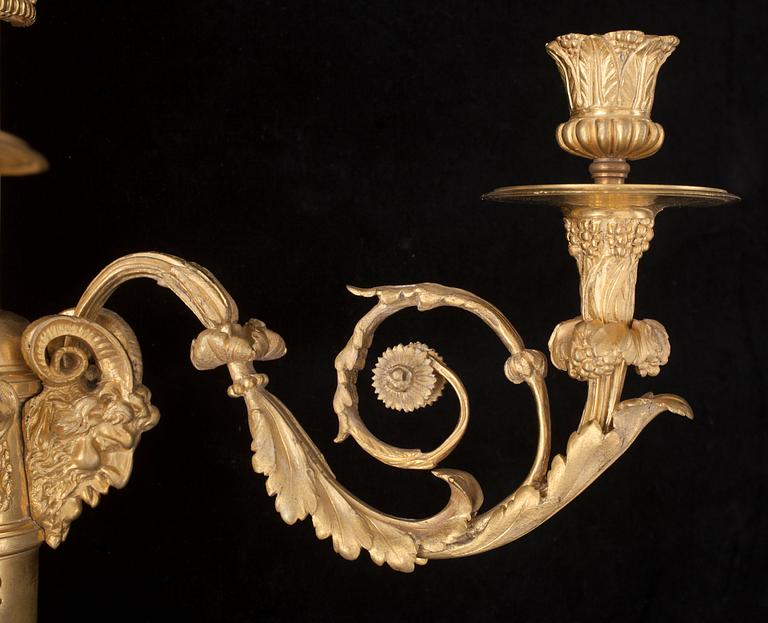 A pair of Louis XVI-style 19th century gilt bronze three-light wall-lights.
