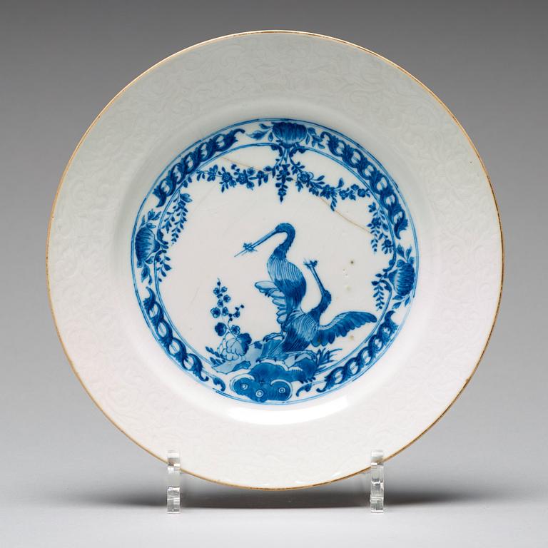 A set of four blue and white armorial dinner plates, Qing dynasty, 18th Century.