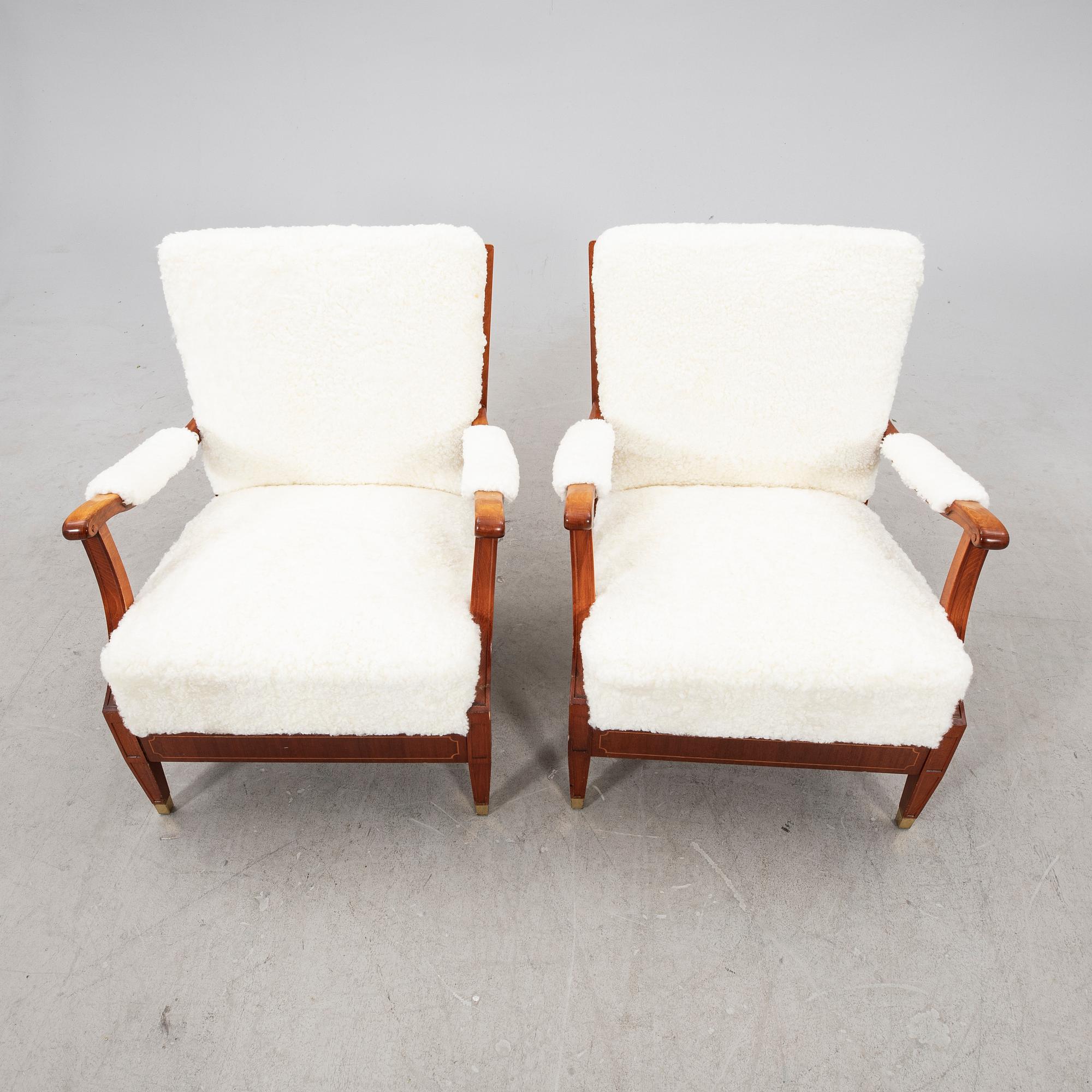 A pair of 1940s cheepskin armchairs.