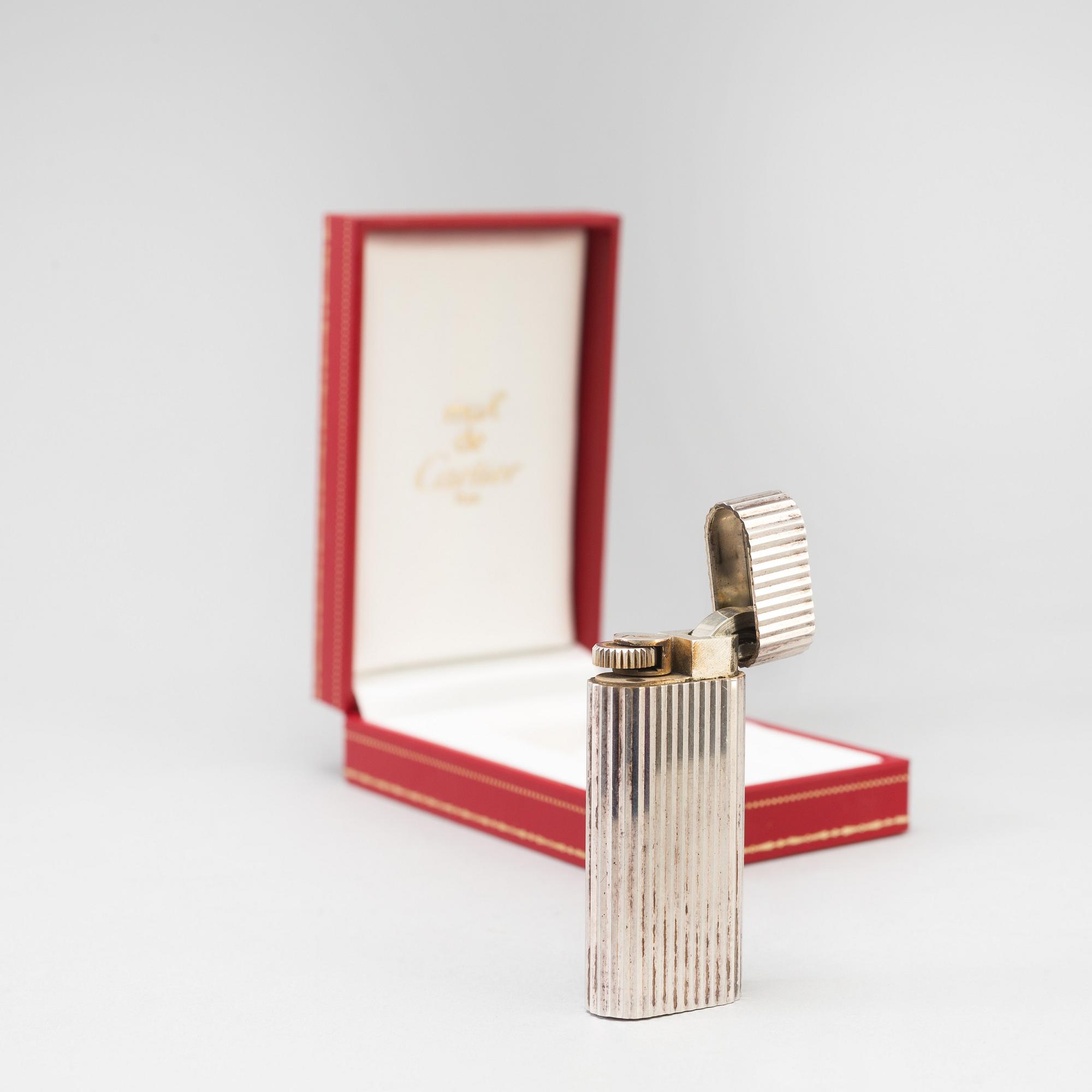 a 20th century Cartier lighter with original box from Paris.