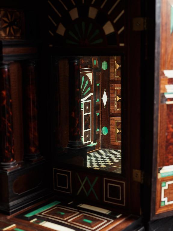 A Louis XIV and Louis XIV-style carved ebony, ivory and tortoiseshell-inlaid cabinet on stand, 17th and 19th century.