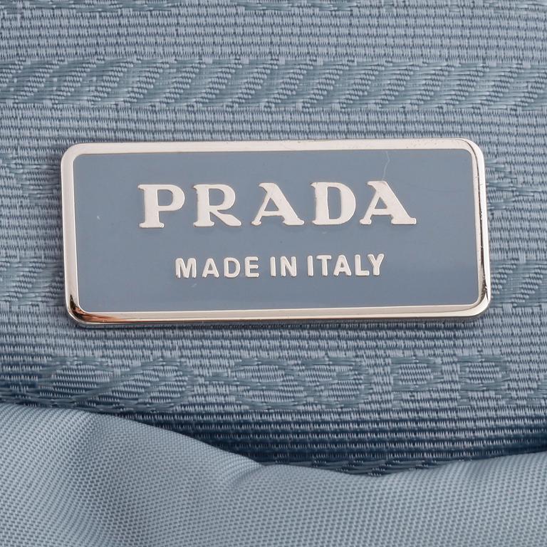 PRADA, a blue nylon crossbody bag.