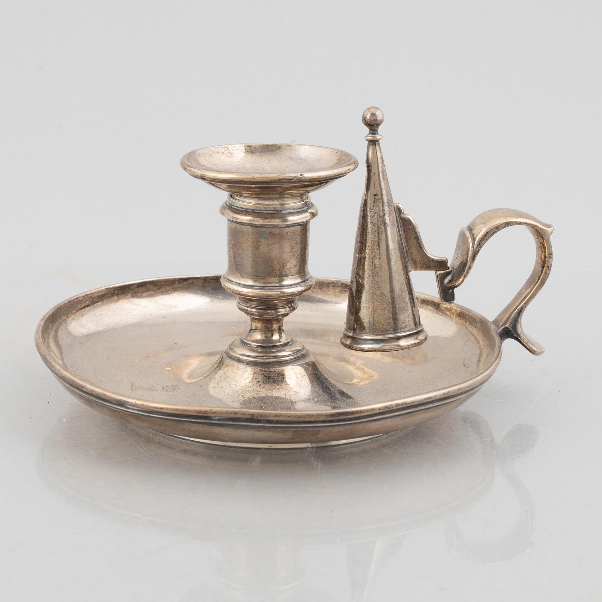 A silver chamber candlestick with mark of R & S Garrard & Co, London, England 1848.