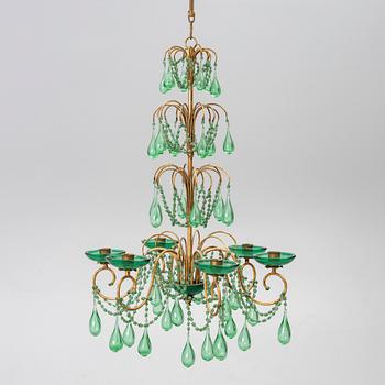 A chandelier, likely from Italy, circa 1950.