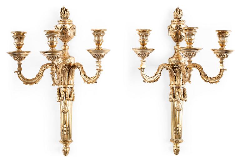 A pair of Louis XVI-style 19th Century three-light wall-lights.