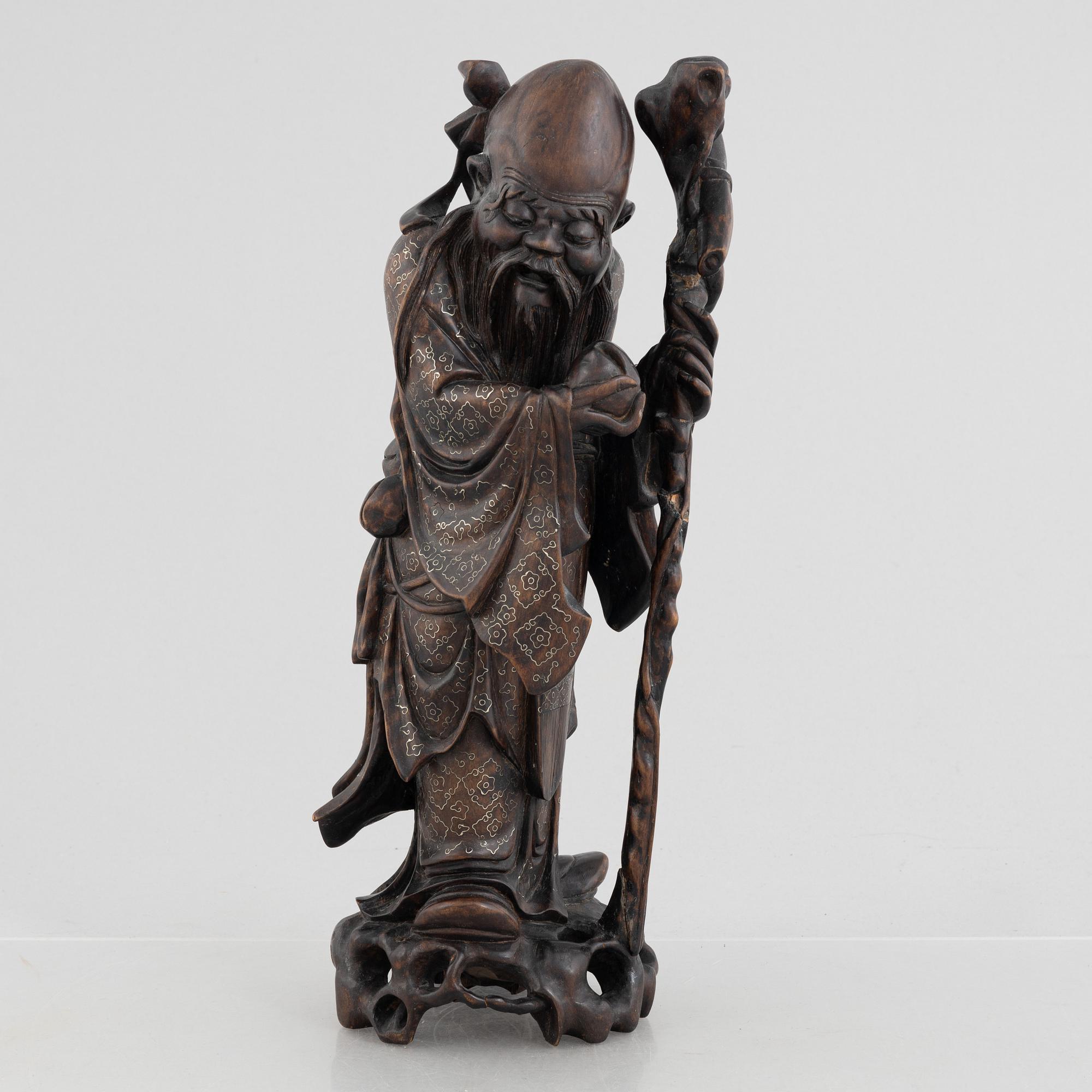A Chinese wooden figure of 'Shoulao' with silver inlays, 20th century.