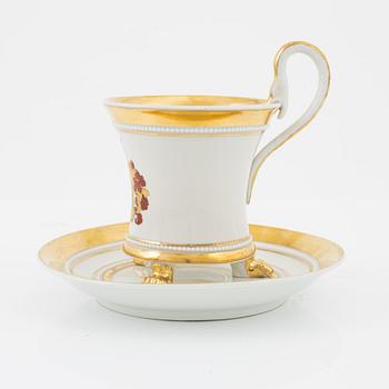 An Empire style porcelain cup and saucer, Germany, circa 1900.