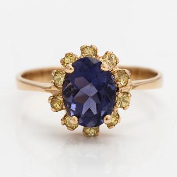 An 18K gold ring with a tanzanite and yellow sapphires.