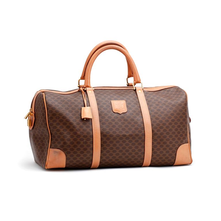 CÉLINE, a brown coated monogram canvas weekend bag.