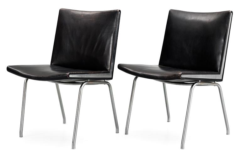 A pair of Hans J Wegner 'Kastrup' steel and black leather chairs, AP-stolen, Denmark.