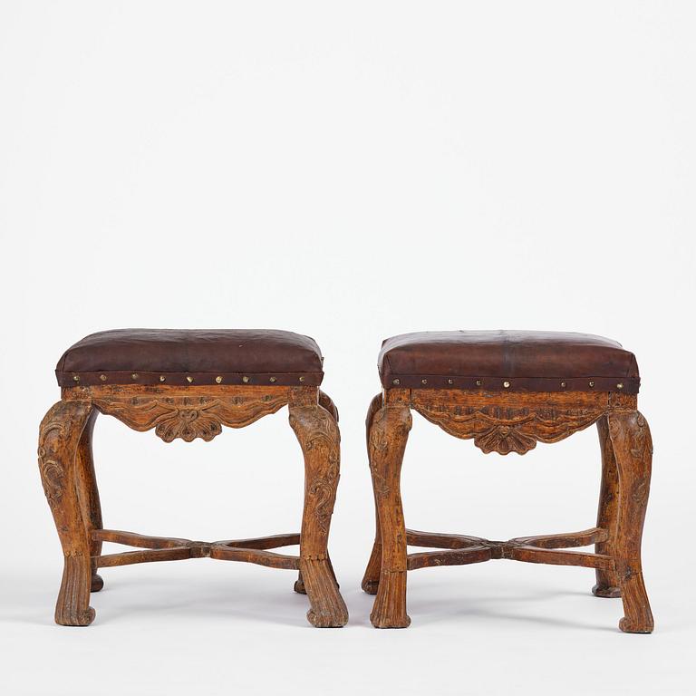 A pair of carved stools in the manner of Jonas Granberg, Jämtland, Sweden, mid 18th century.