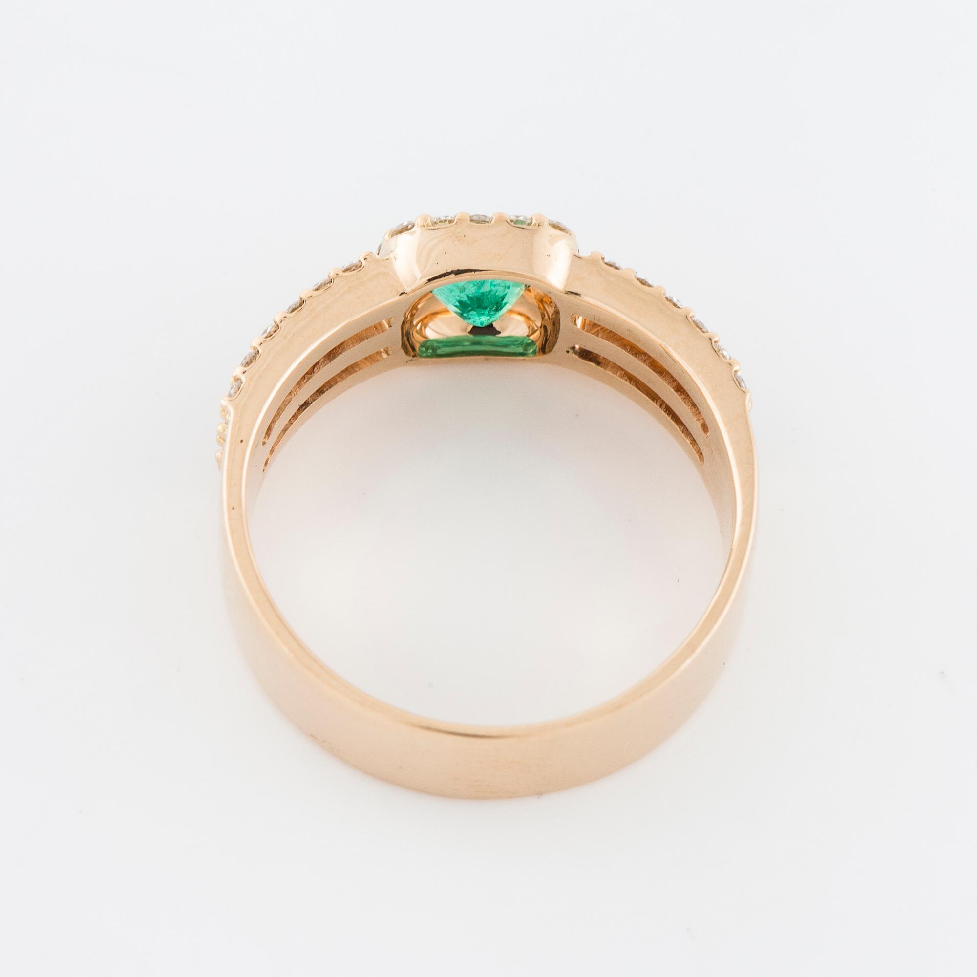 A faceted emerald and brilliant cut diamond ring.